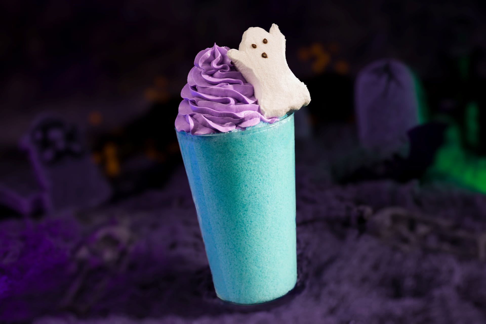 A blue cup with purple whipped cream and a marshmallow ghost, inspired by Mickey's Not So Scary Halloween Party 2025.