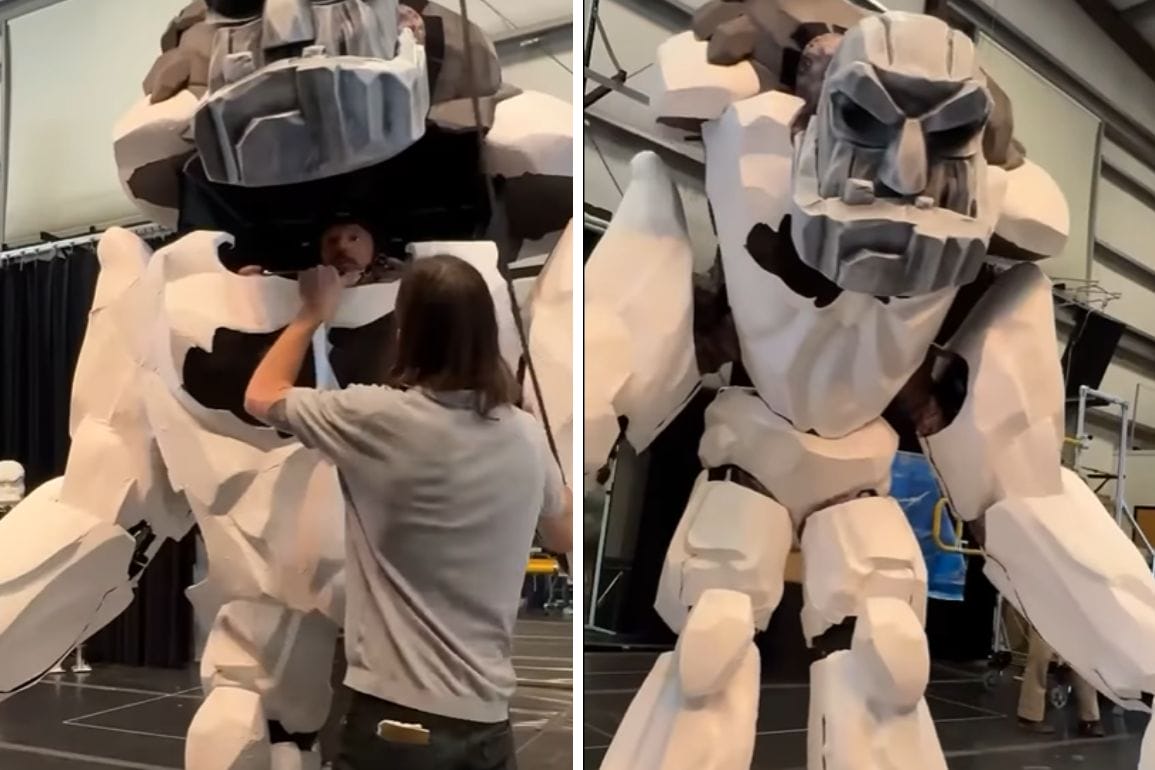A person helps assemble a giant Titan puppet costume in a workshop for the Hercules Show on the Disney Destiny Cruise Ship.