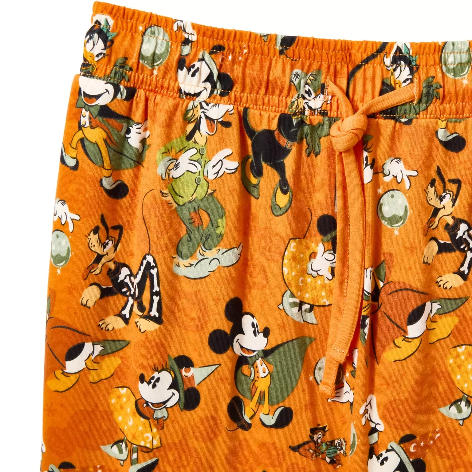 Orange pajama pants with Disney Store Halloween characters like Mickey, Goofy, and Pluto dressed in festive costumes.