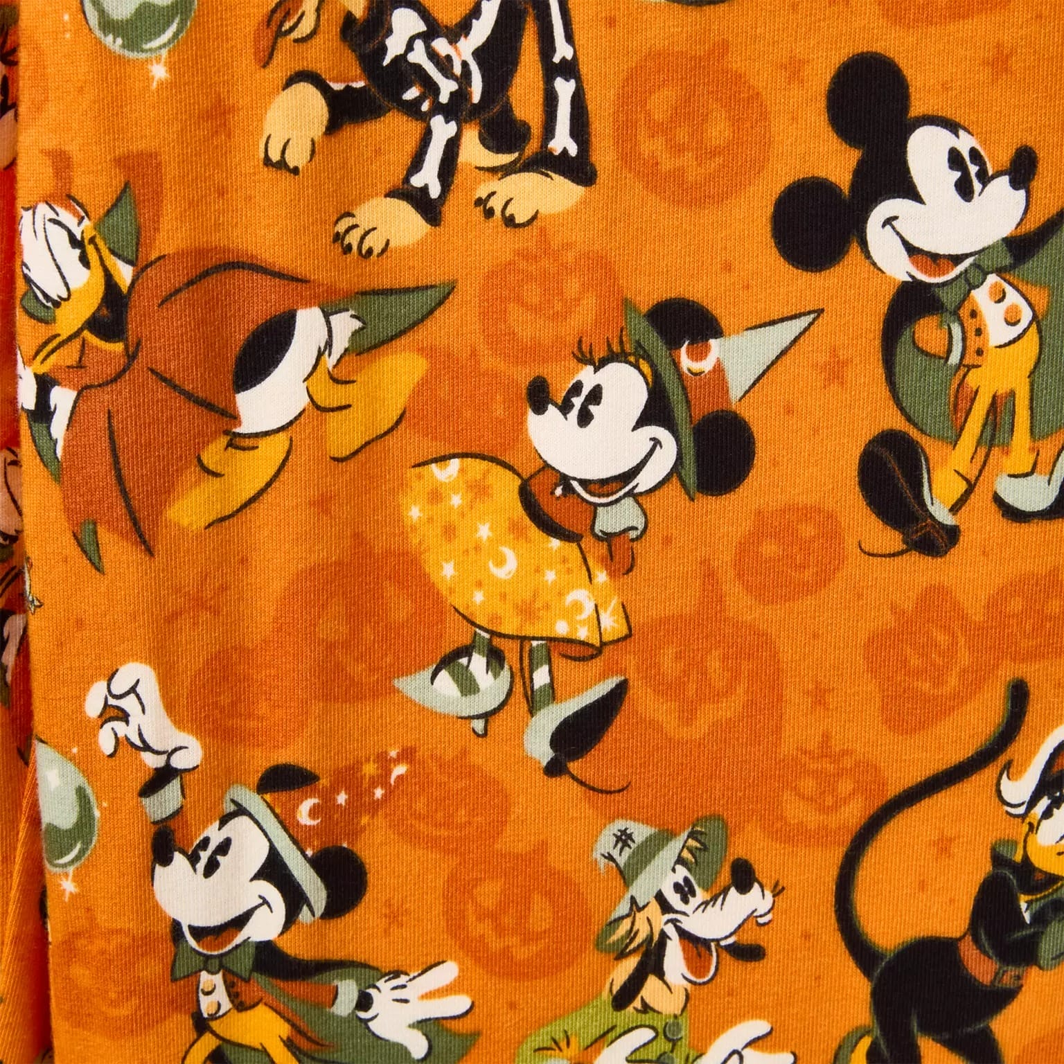 Cartoon Mickey and Minnie Mouse in Halloween costumes with pumpkins, moons, and Disney Store Halloween merchandise.