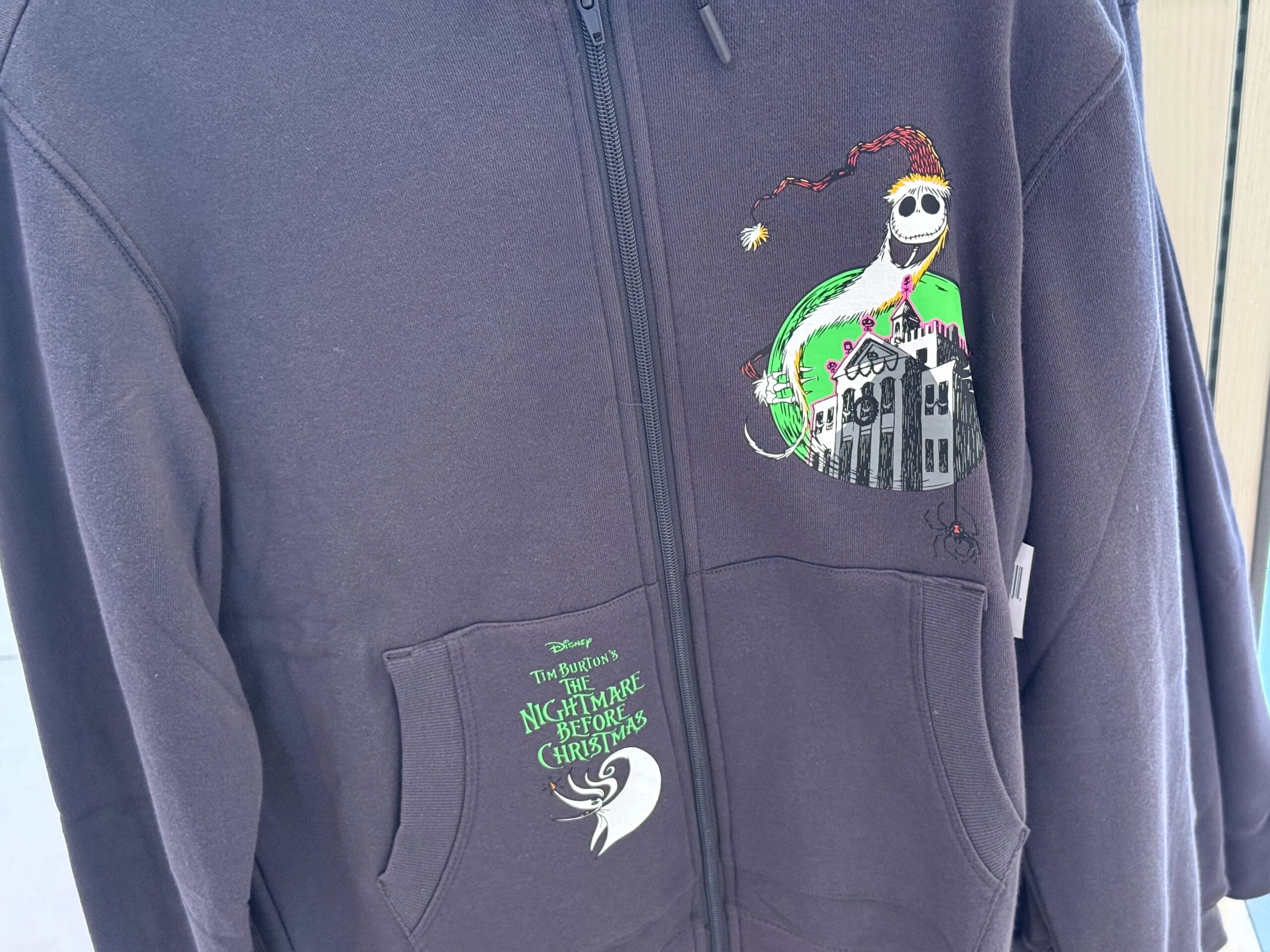 Black hoodie featuring Jack Skellington in a Santa hat, inspired by Disneyland's Haunted Mansion Holiday merchandise.