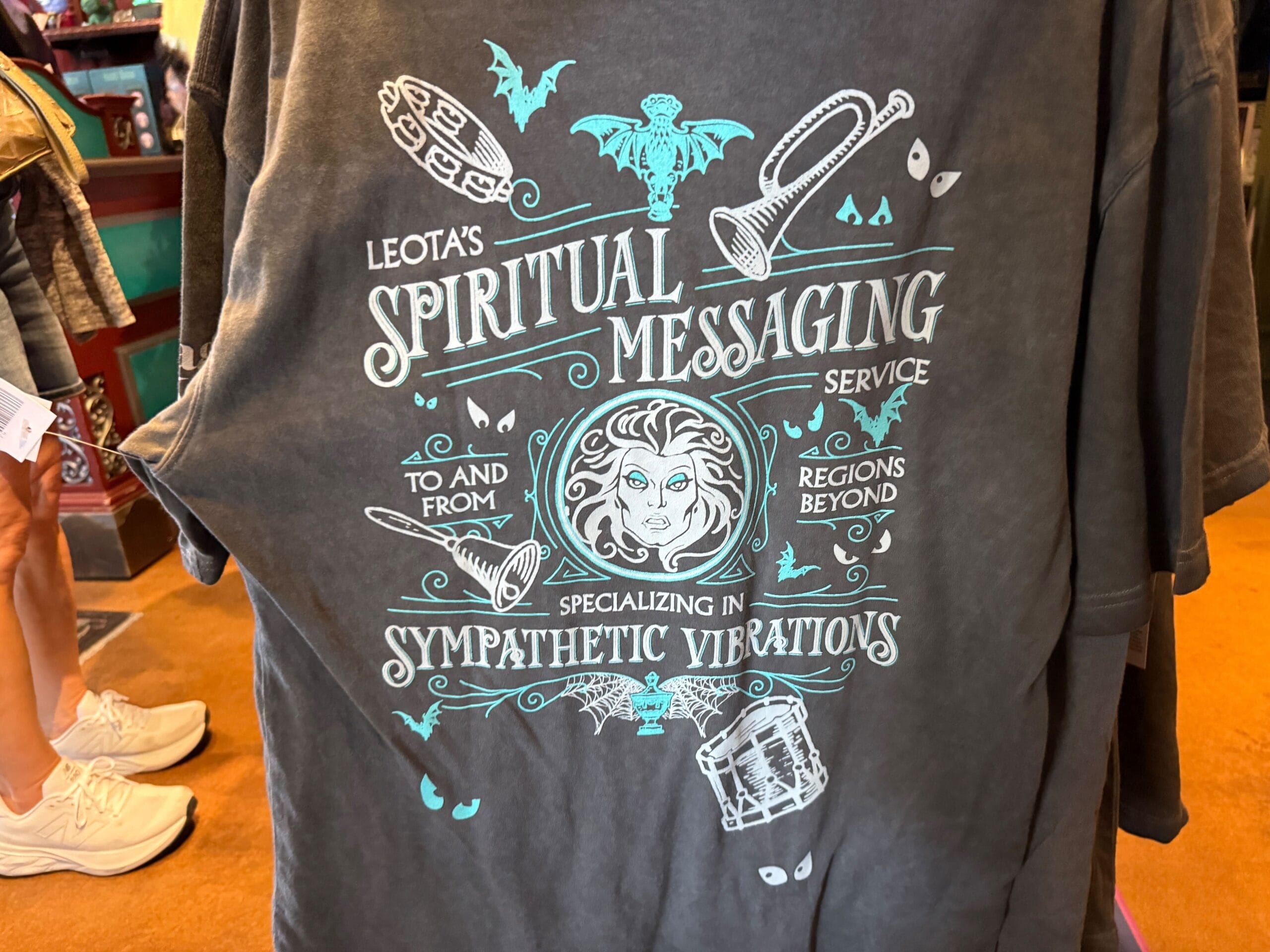 Gray t-shirt with "Leota's Spiritual Messaging" design, inspired by HM Merchandise from Disneyland.