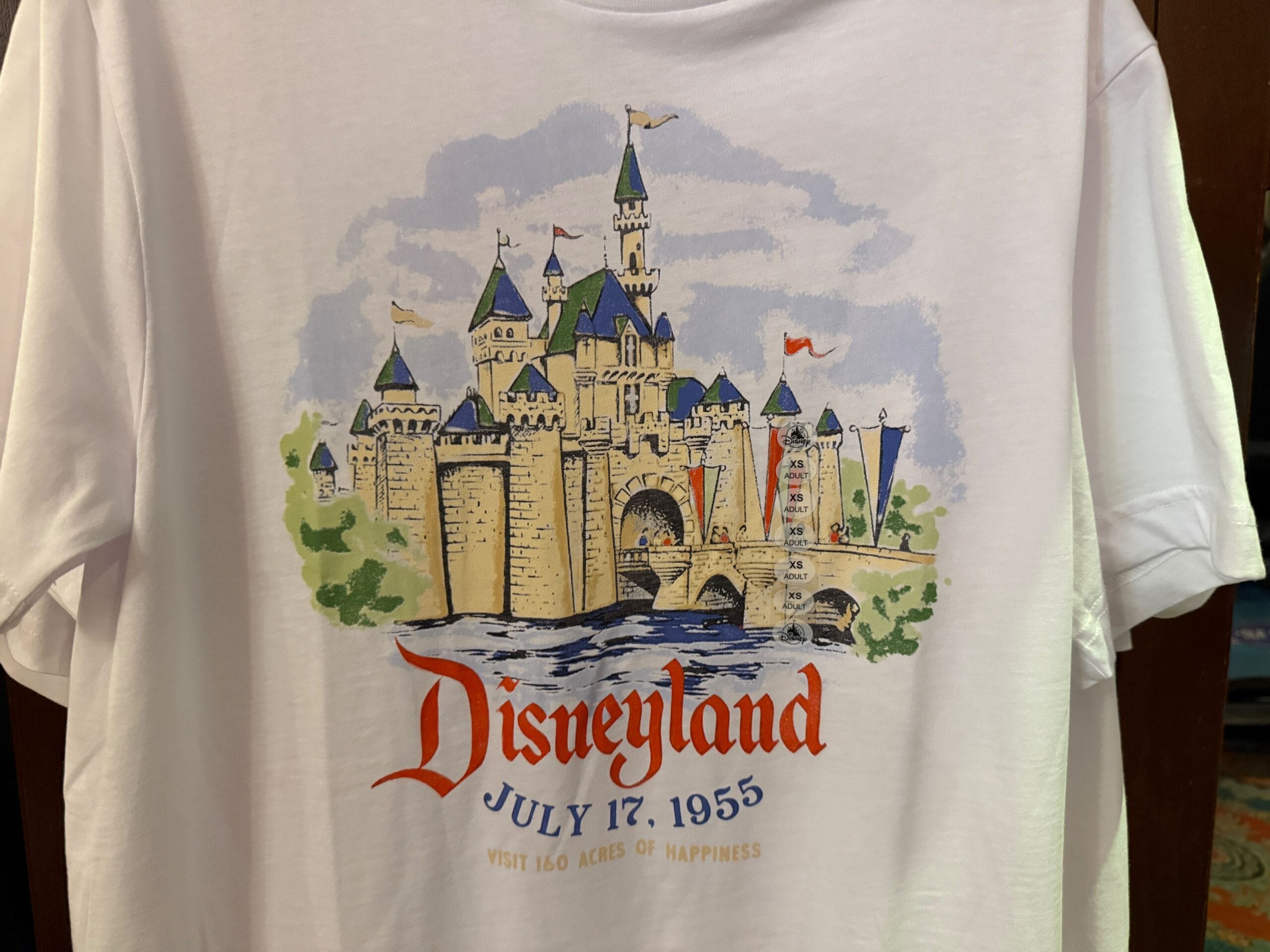 White shirt with an illustrated Sleeping Beauty Castle, "Disneyland July 17, 1955" and "Visit 160 Acres of Happiness.