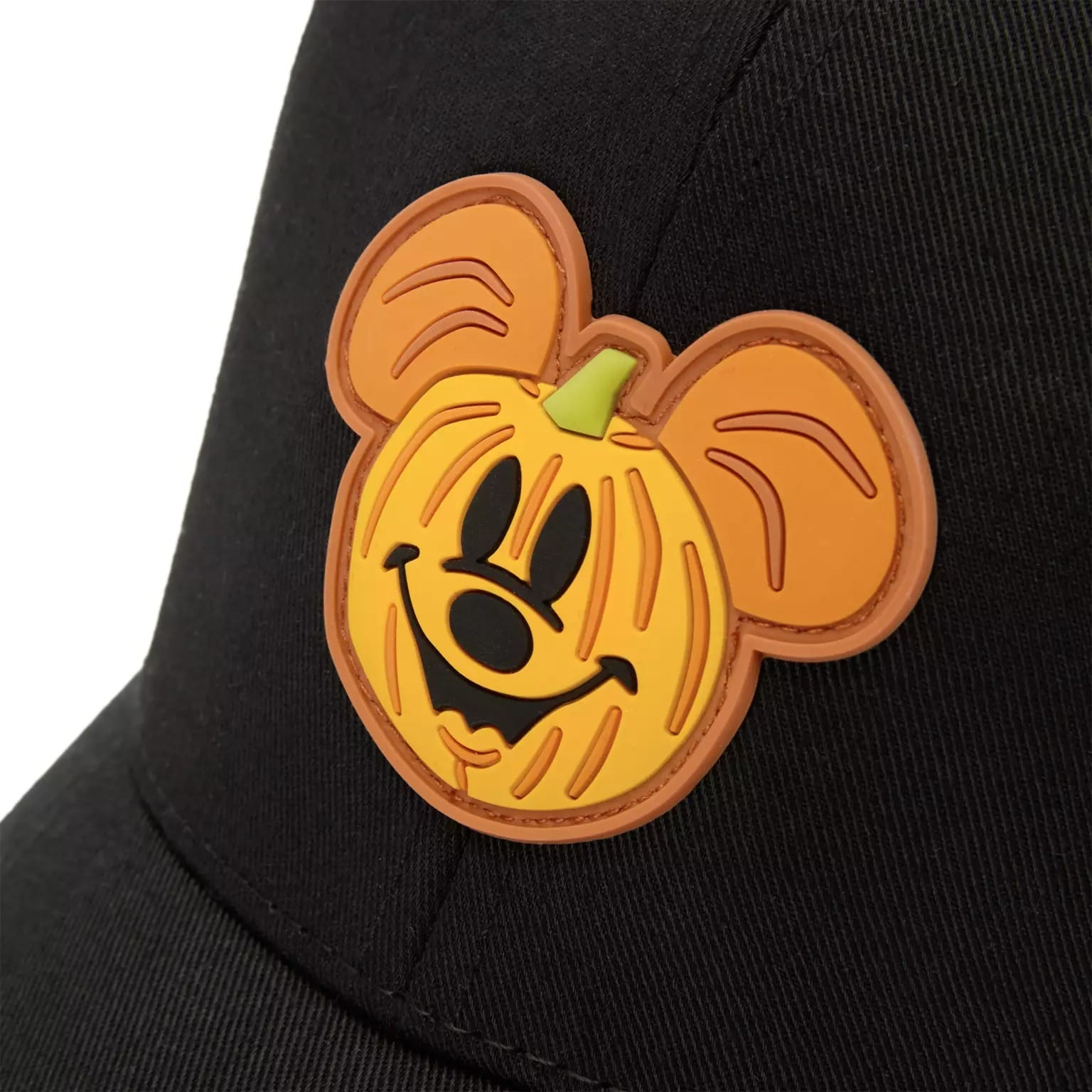 A black hat with a patch of Mickey Mouse’s jack-o’-lantern face, perfect for Disney Store Halloween merchandise.