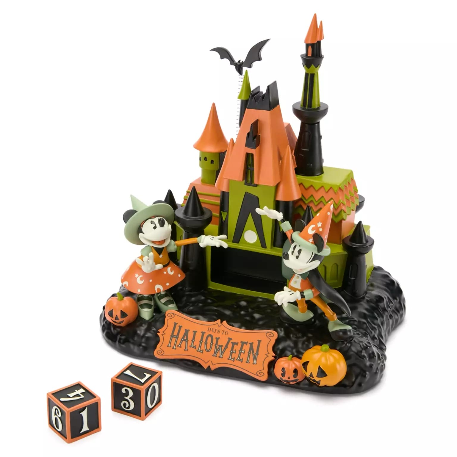 Mickey and Minnie in Halloween costumes beside a spooky house with pumpkins and Disney Store Halloween countdown blocks.