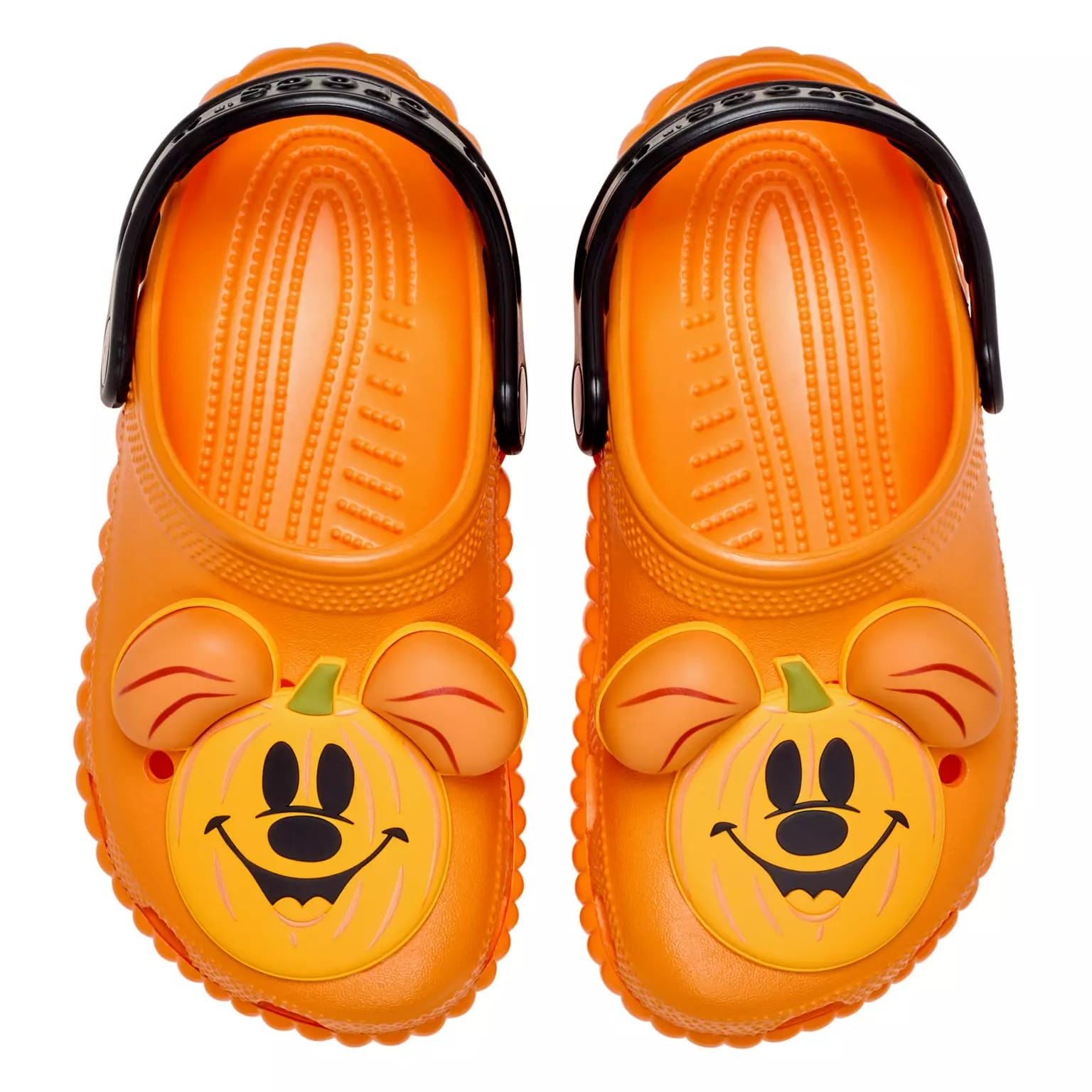Orange clogs with black straps feature a cartoon pumpkin face with mouse ears, perfect Disney Store Halloween merchandise.