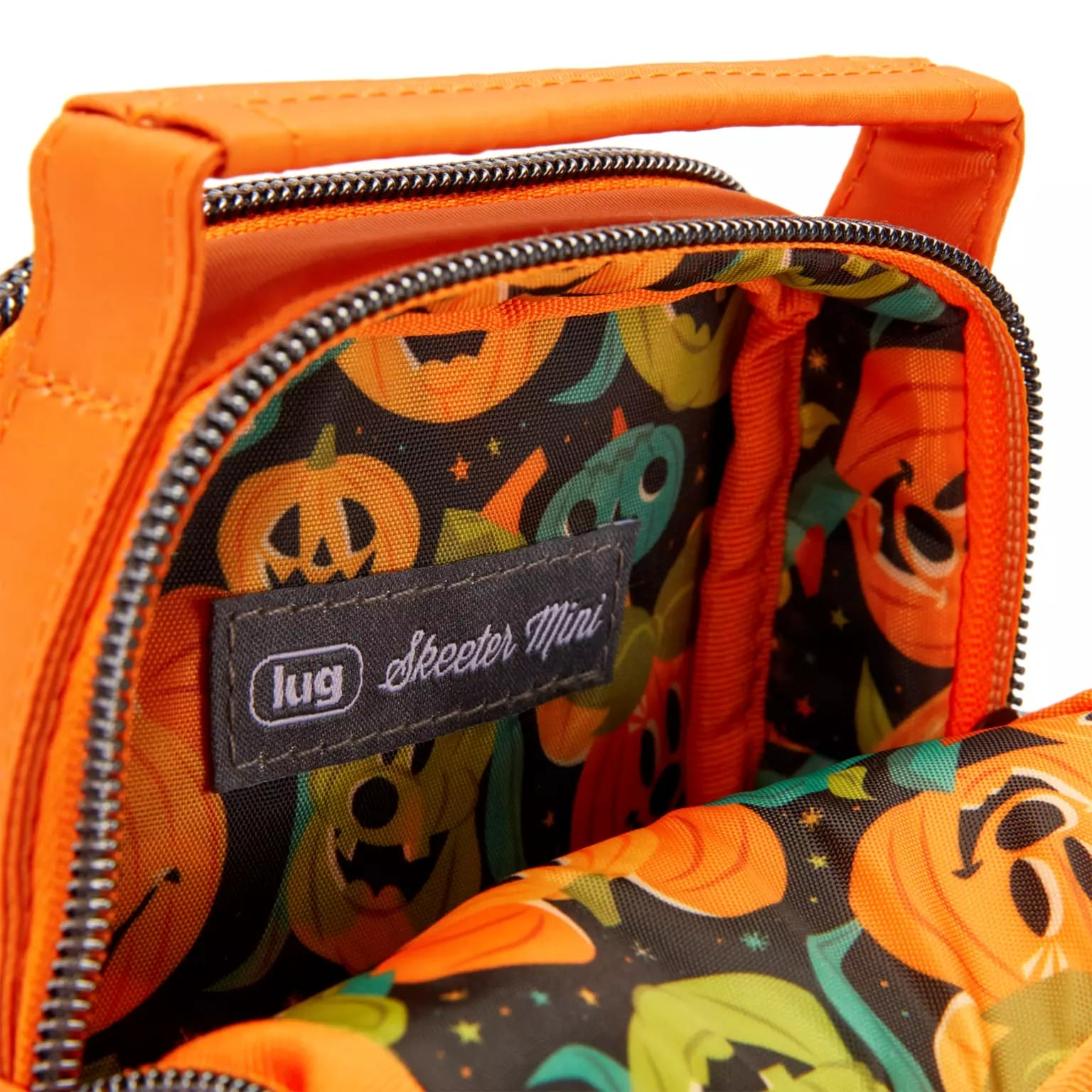 Close-up of an orange bag's interior with pumpkin pattern, part of new Disney Store Halloween merchandise.