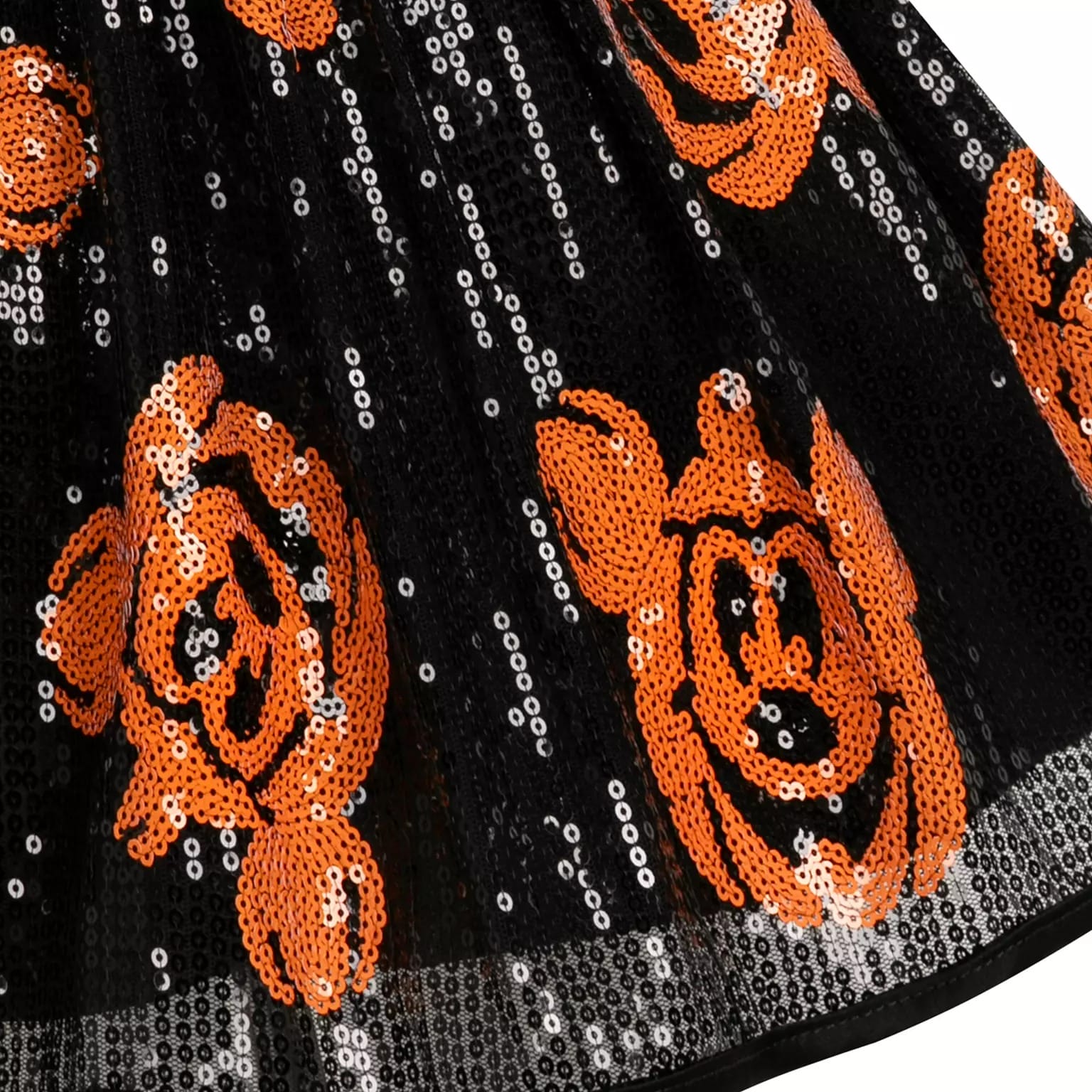 Black fabric with silver sequins and orange Mickey Mouse pumpkins, part of Disney Store Halloween merchandise.