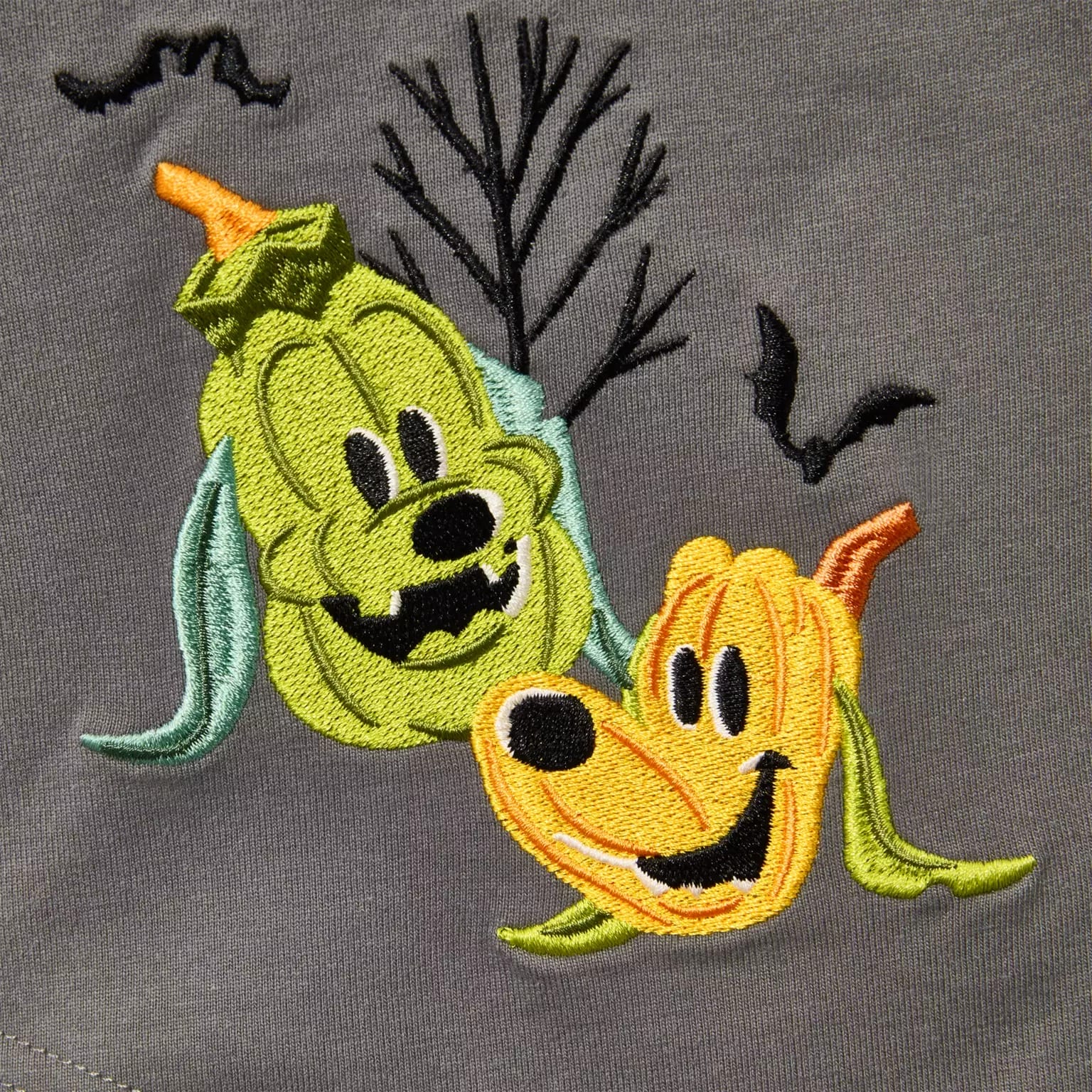Two pumpkin jack-o’-lanterns embroidered as Pluto, with bats and a tree—fun Disney Store Halloween merchandise.