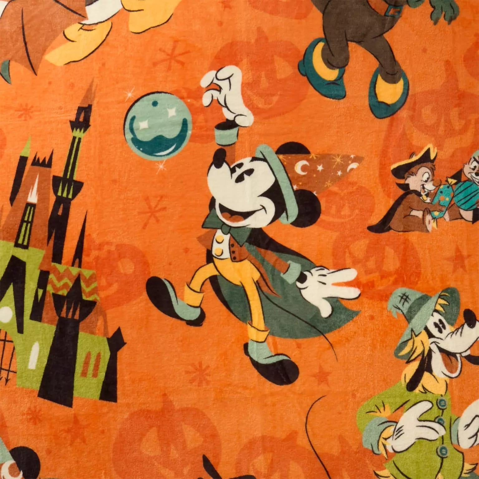 Cartoon mice in Halloween costumes with a castle and pumpkins on orange, inspired by Disney Store Halloween merchandise.