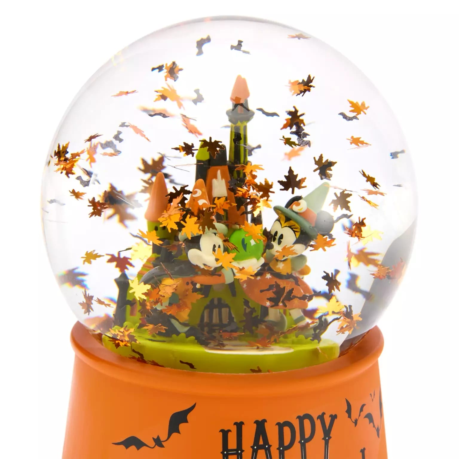 A Halloween-themed snow globe, part of Disney Store Halloween merchandise, features Mickey, Minnie, and a spooky castle.