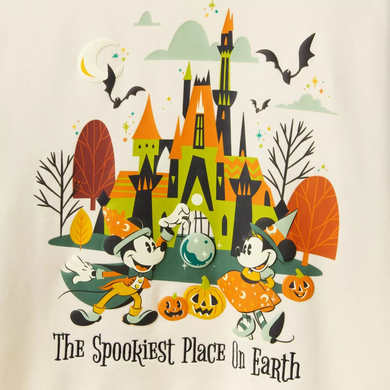 Mickey and Minnie in Halloween costumes near a haunted castle, showcasing Disney Store Halloween merchandise.