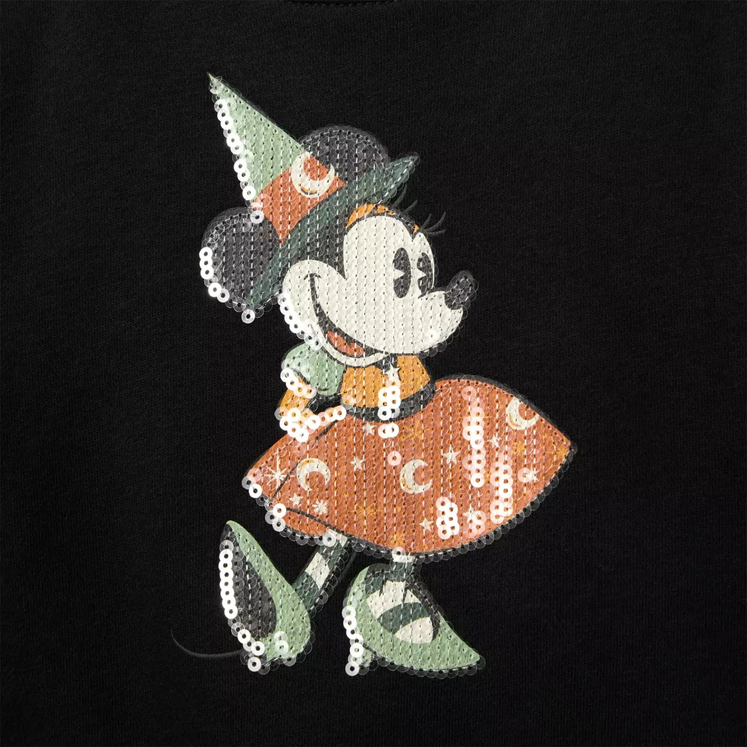 Minnie Mouse dressed as a witch in green and orange, part of the new Disney Halloween products with sequins and moons.