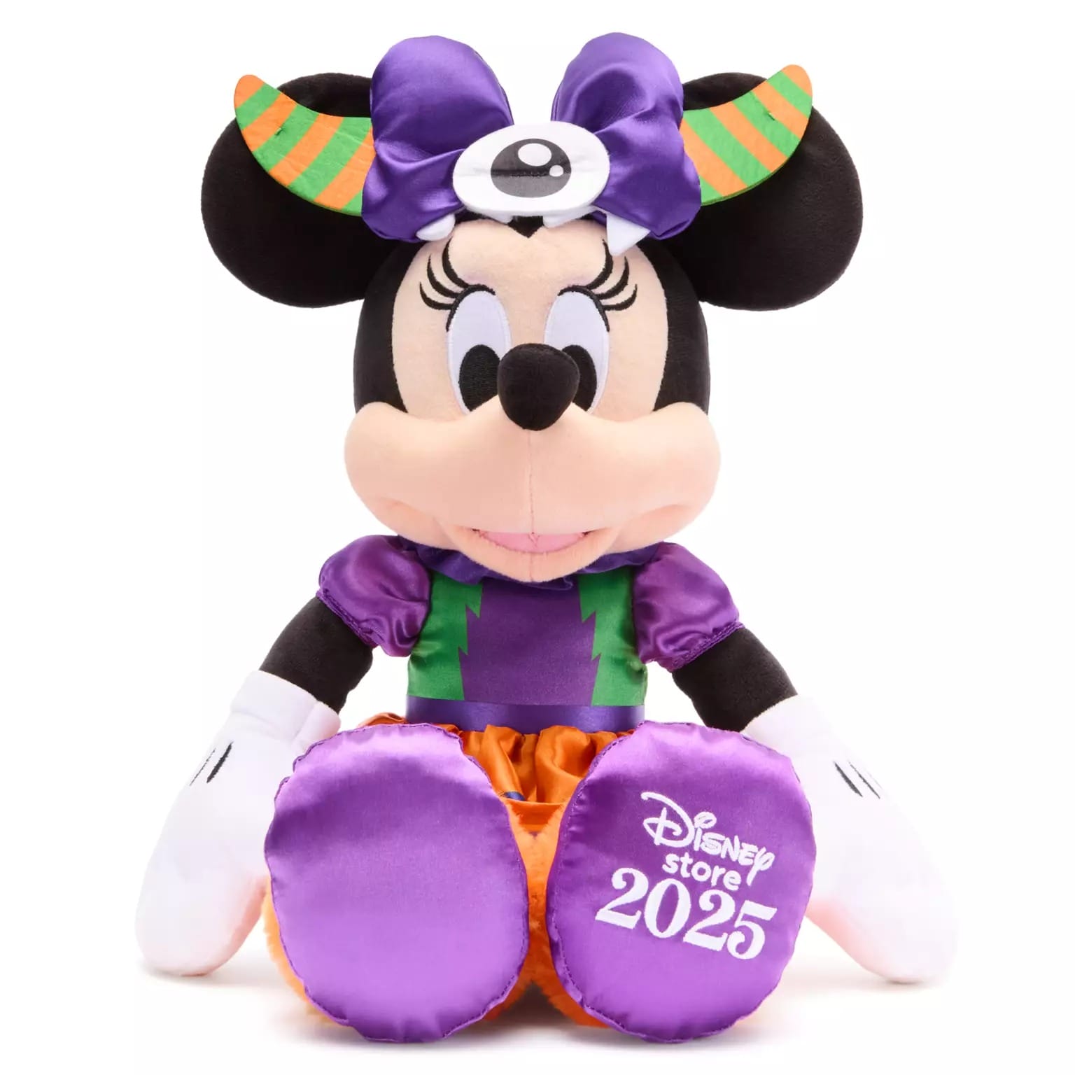 Plush Minnie Mouse in a Halloween costume, part of Disney Store Halloween merchandise, with "Disney Store 2025" on her foot.