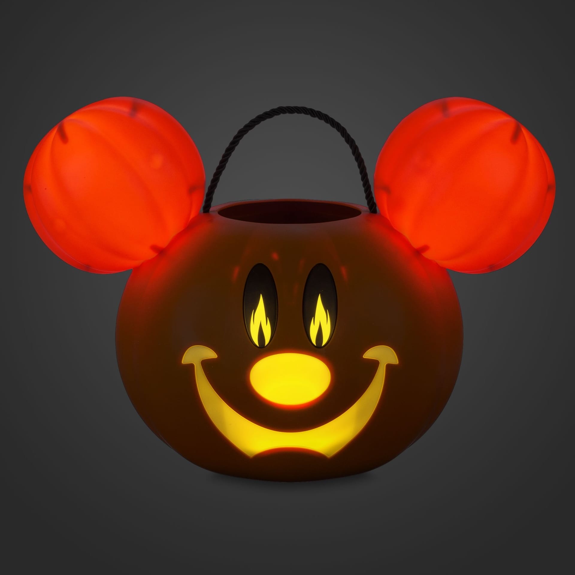 A glowing pumpkin bucket shaped like a cartoon mouse face from the 2025 Mickey Mouse Halloween Collection.