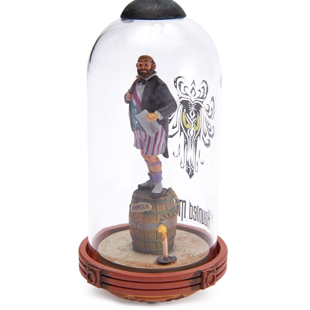 A bearded man in striped shorts stands on a "Danger" barrel, inside a glass dome from the Haunted Mansion Collection.