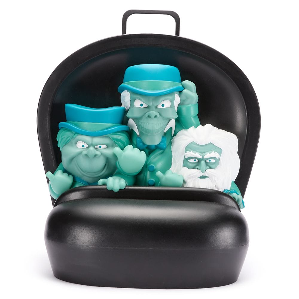 Three cartoony ghost figures from Haunted Mansion in a black ride seat, all wearing hats and making expressive faces.