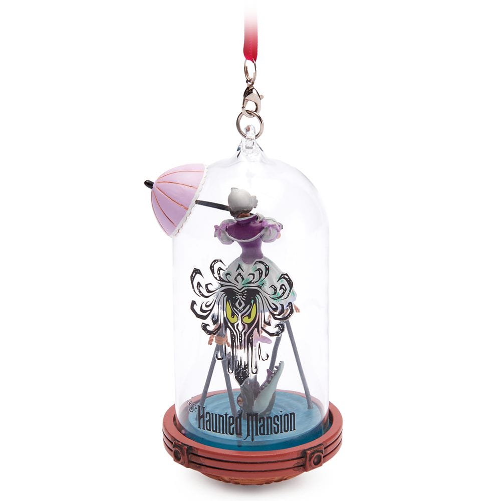 Haunted Mansion ornament from Disney Store: a woman with a pink umbrella in a glass dome, hanging from a red ribbon.