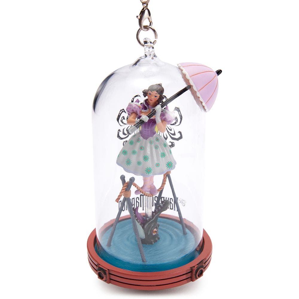 Ornament of a woman in a bonnet on a tightrope above an alligator, from the Disney Store Haunted Mansion Collection.