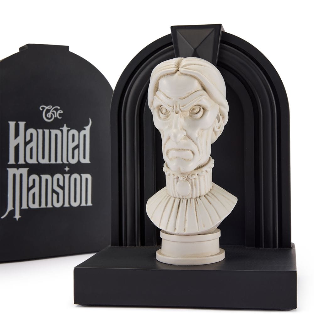 A white Haunted Mansion bust with a stern face, set on a black stand, from the Disney Store.