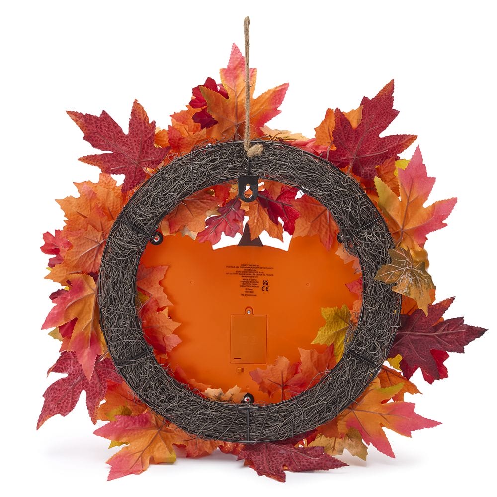 A fall wreath with red, orange, and yellow leaves shown from the back, revealing a hanging loop and frame.