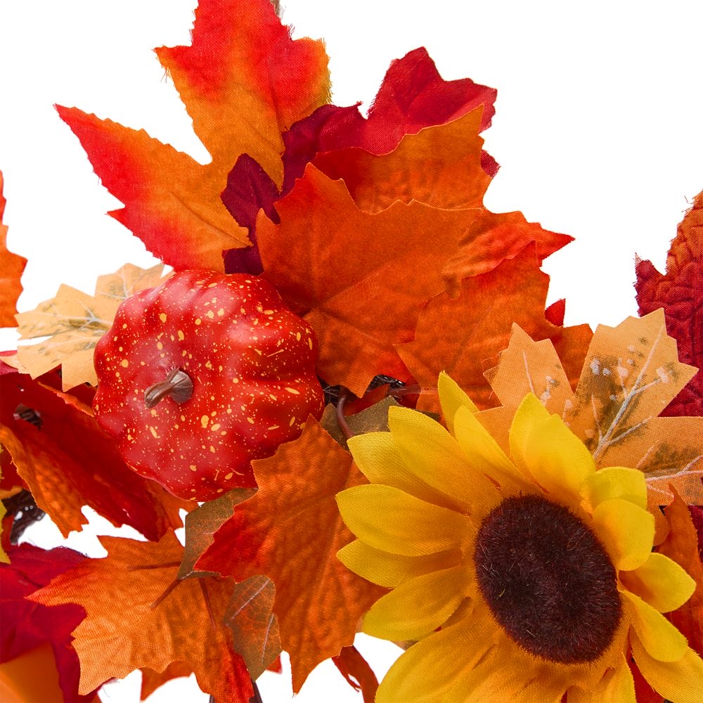 Bright autumn leaves, a small orange pumpkin, and a yellow sunflower evoke a Mickey Mouse Halloween on a white background.