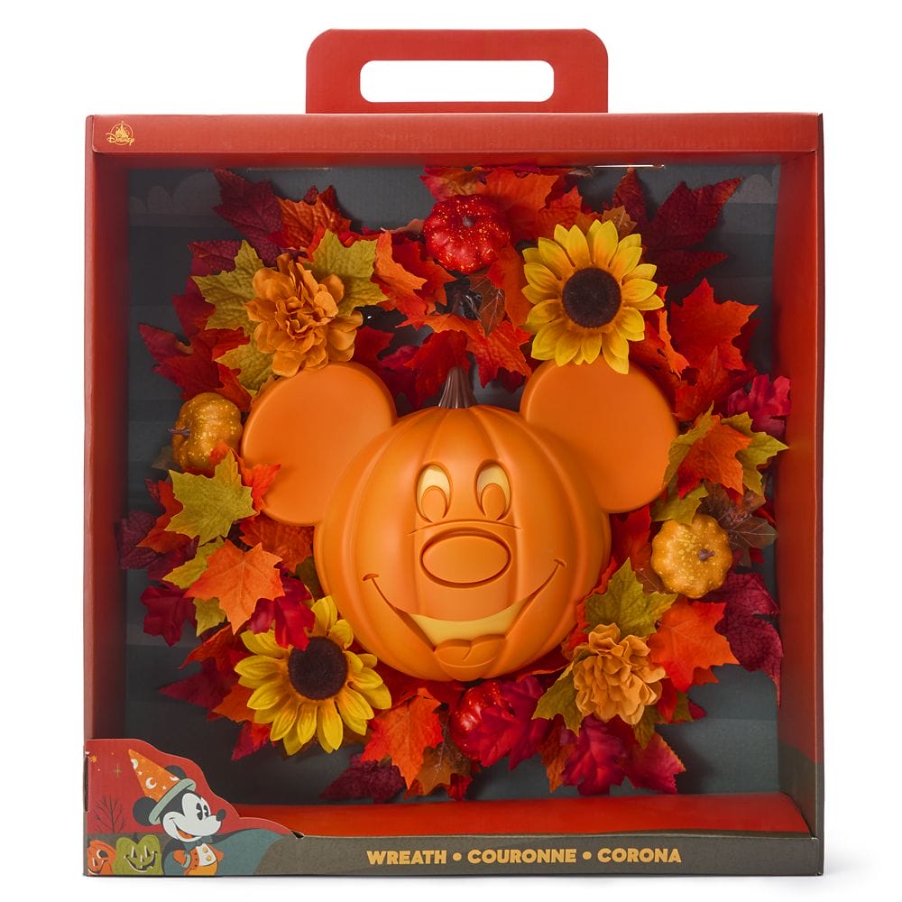 A Mickey Mouse Halloween wreath with autumn leaves, sunflowers, and pumpkins, displayed in a Disney Store box.