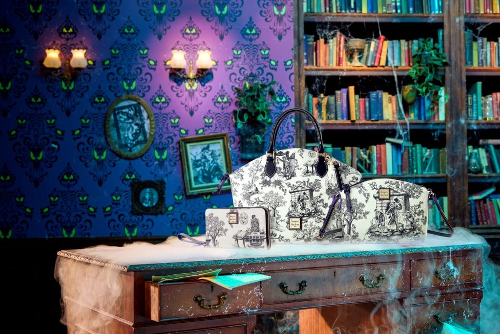 Black-and-white handbags on a foggy desk in a spooky, colorful library like a haunted mansion, glowing eyes on wallpaper.