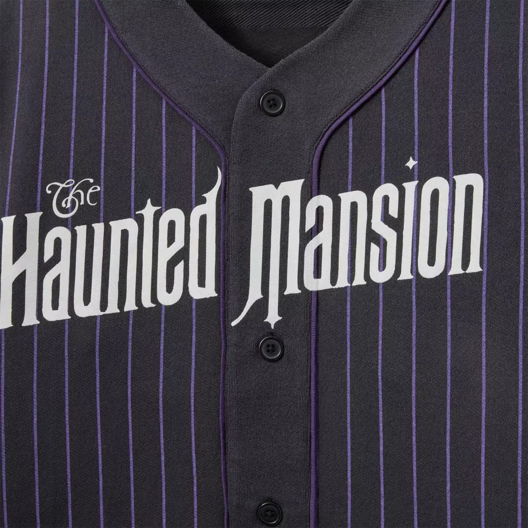 A black pinstriped shirt from the Haunted Mansion Collection with "The Haunted Mansion" in white Gothic letters across the front.