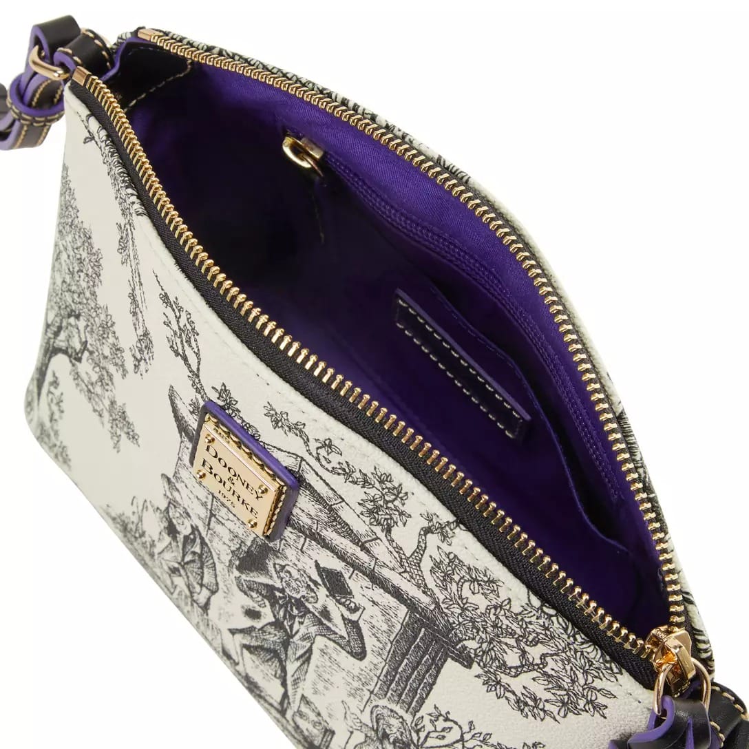 White and black toile print purse from the Haunted Mansion Collection, gold zipper, purple lining, shown open from above.