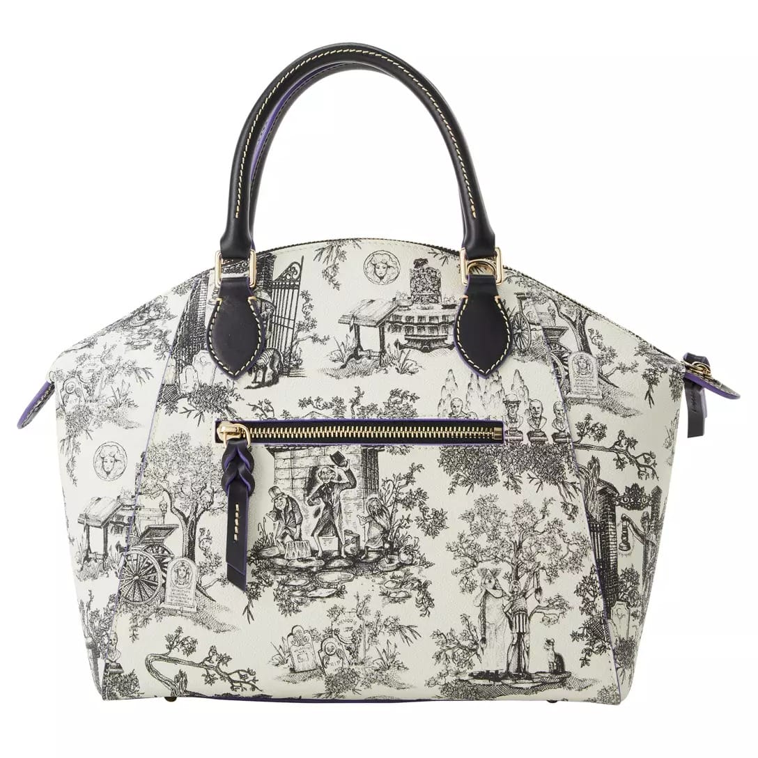 White handbag with black handles and toile illustrations, part of the Haunted Mansion Collection at Disney Store.
