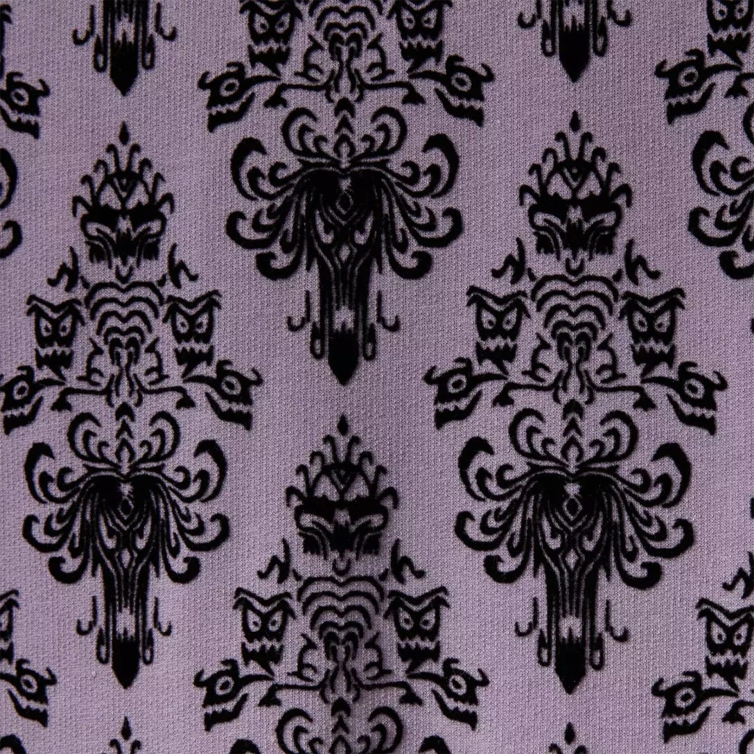 Black ornate damask pattern with symmetrical, abstract shapes on a purple background, inspired by the Haunted Mansion.