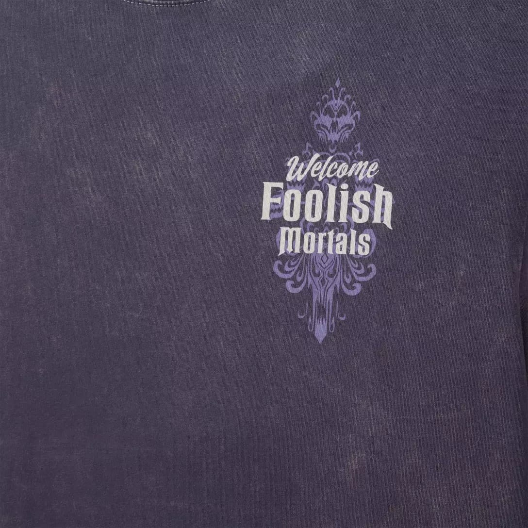 Purple shirt from the Haunted Mansion Collection with "Welcome Foolish Mortals" text on the upper left chest area.