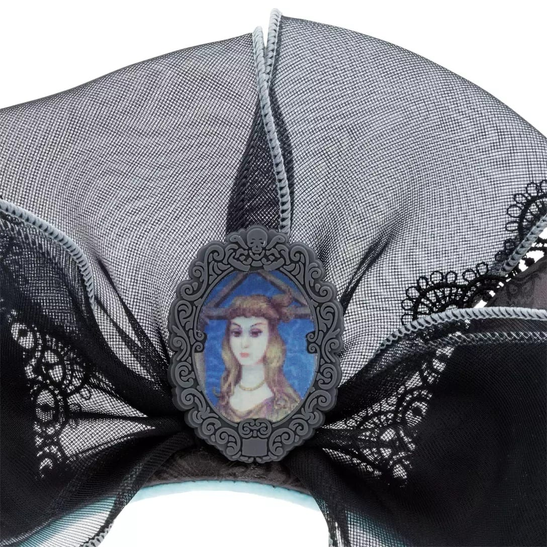 A black lace bow with a portrait of a woman, inspired by the Haunted Mansion Collection at Disney Store.