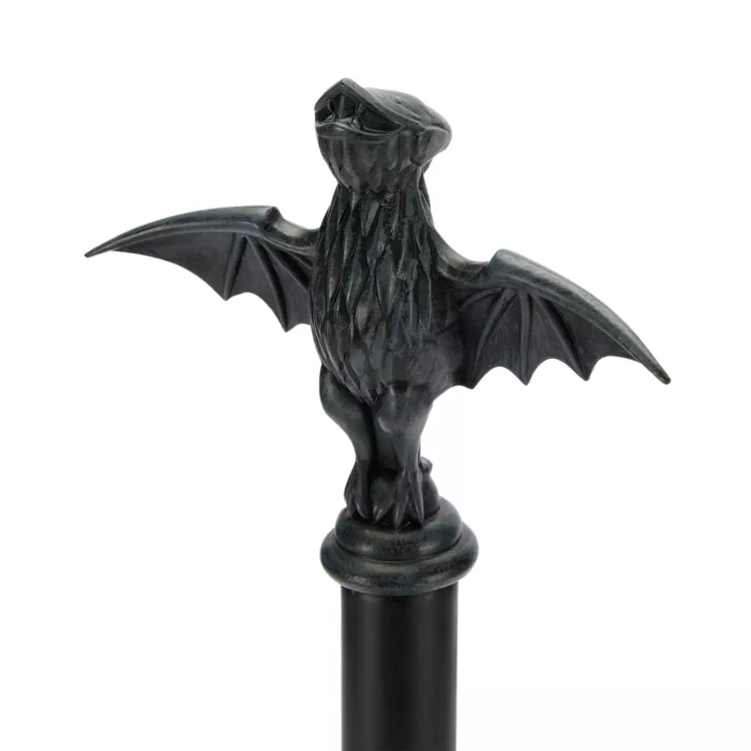 A black metal cane topped with a detailed bat handle, inspired by the Haunted Mansion Collection.