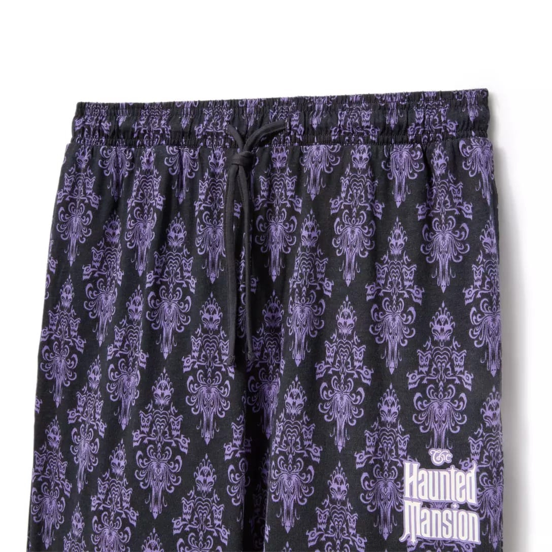 Black shorts with a purple damask pattern from the Haunted Mansion Collection at Disney Store; logo on lower right side.