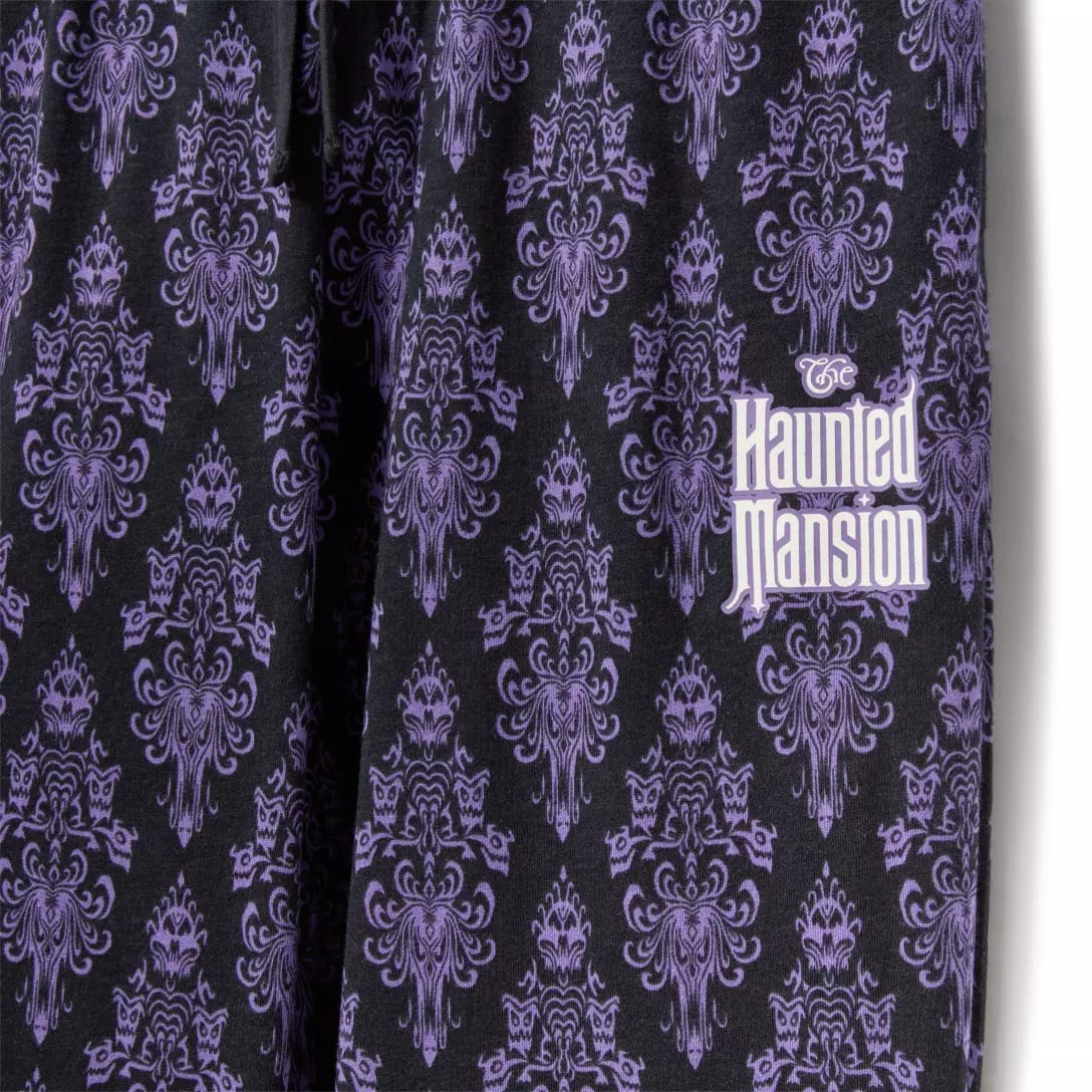 Black fabric with a purple ornate pattern from the Haunted Mansion Collection, featuring the logo in white and purple letters.