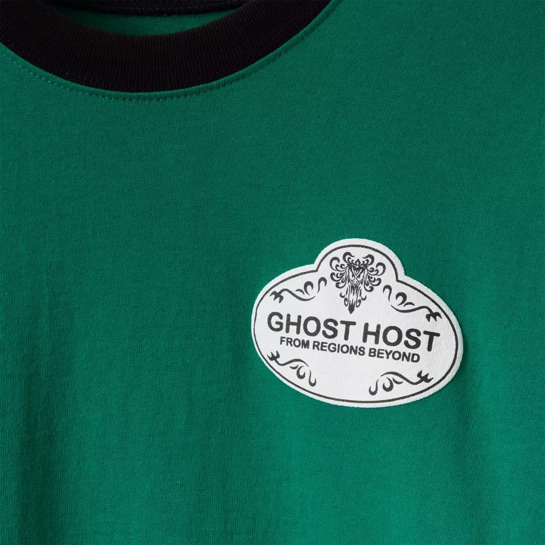 Green shirt from the Disney Store featuring a Haunted Mansion "Ghost Host From Regions Beyond" badge and ornate black design.