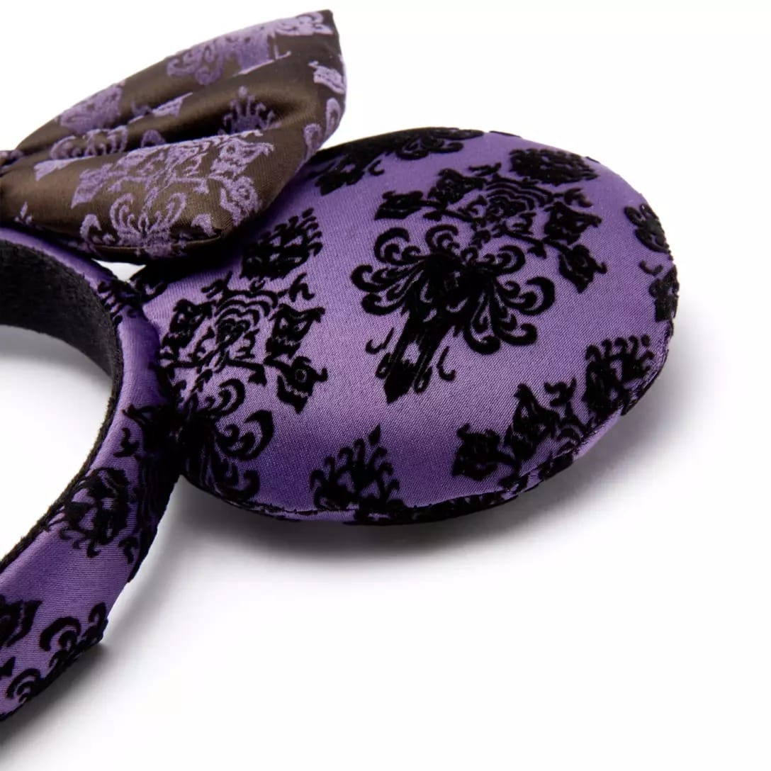 Purple mouse ears headband with black damask and dark bow, part of the Haunted Mansion Collection at the Disney Store.