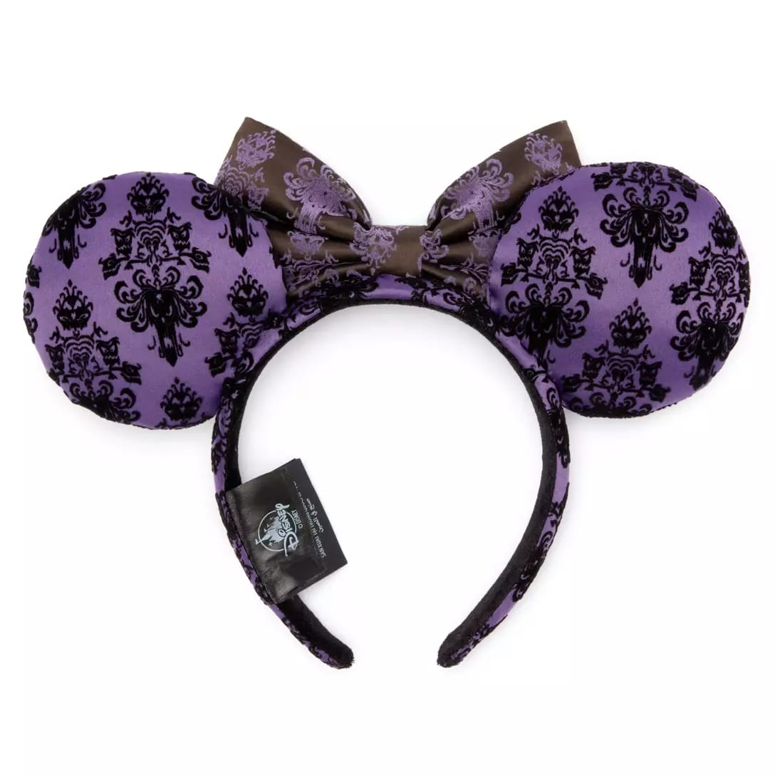 Purple mouse ears headband with black ornate pattern and matching bow, inspired by the Haunted Mansion at Disney Store.
