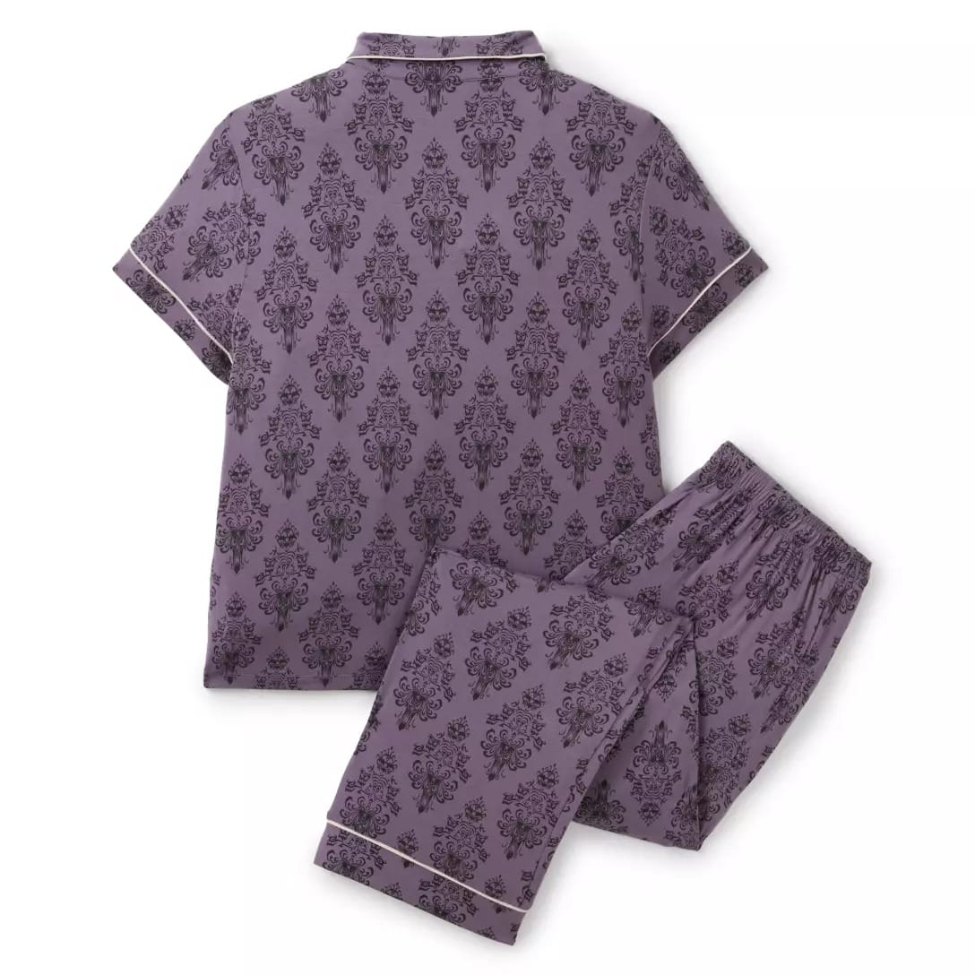 Purple short-sleeve pajama set with a dark damask pattern from the Haunted Mansion Collection, laid flat on white.