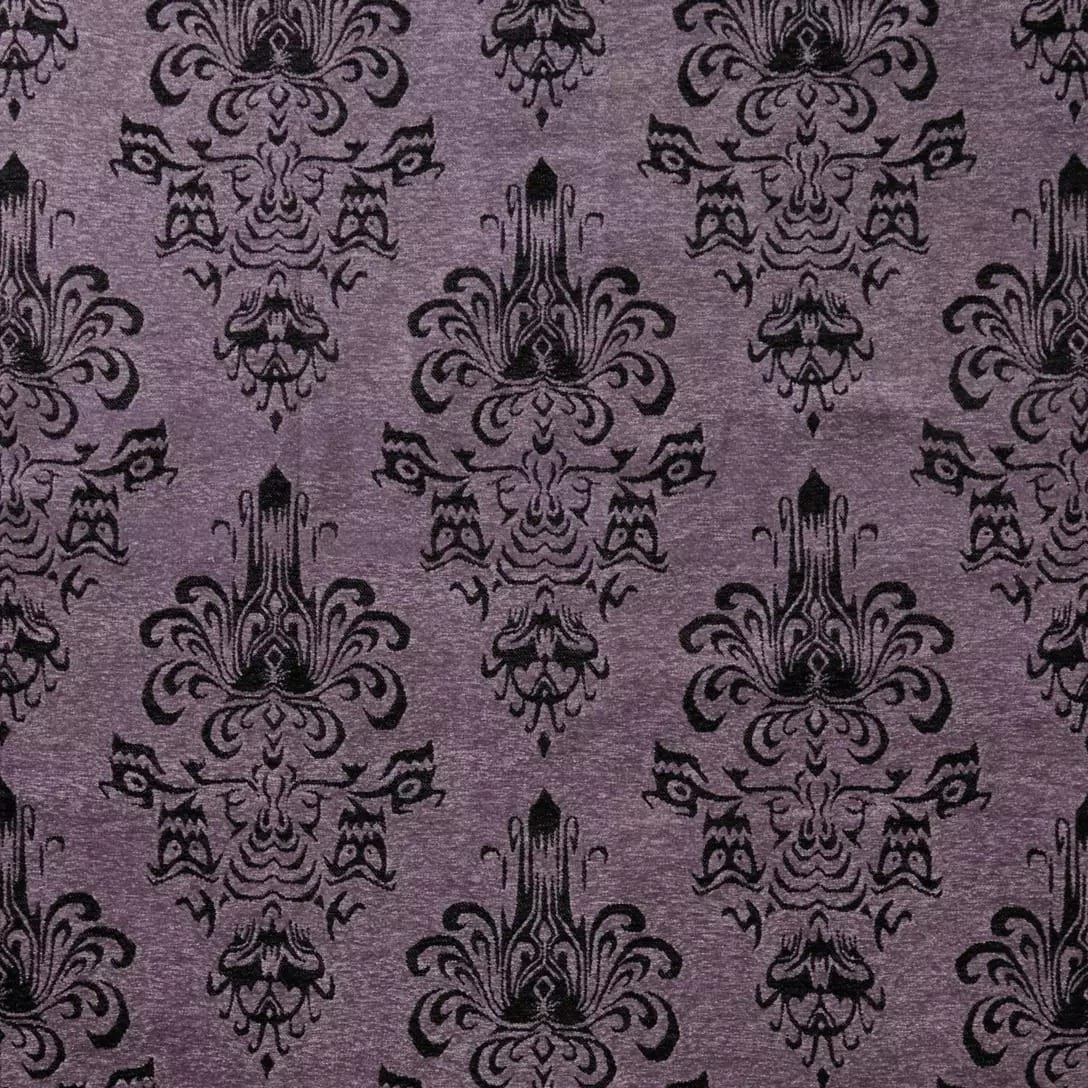 Purple wallpaper with a repeating black damask pattern inspired by the Haunted Mansion Collection at Disney Store.