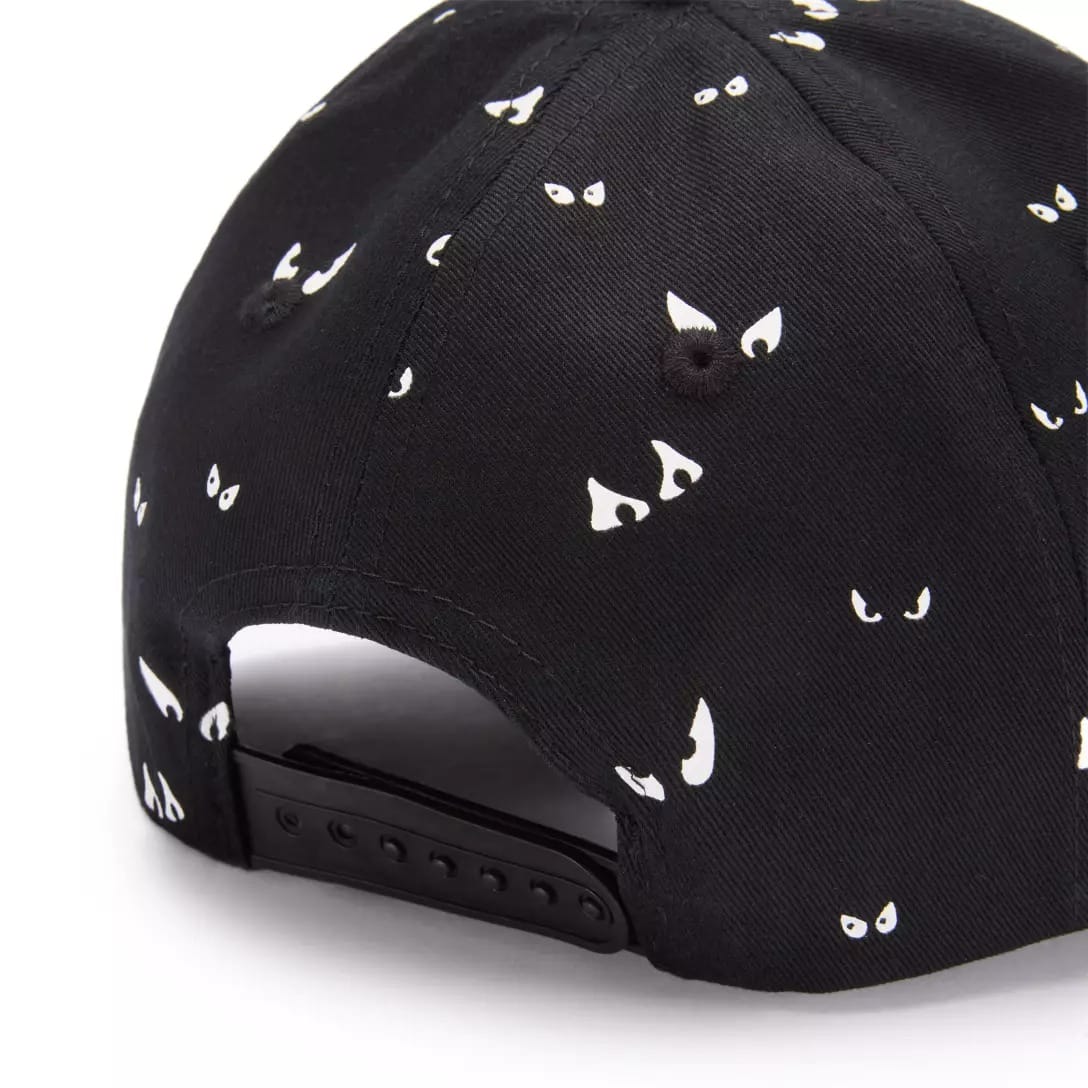 Black baseball cap with small white cartoon eyes from the Haunted Mansion Collection, adjustable snapback at back.