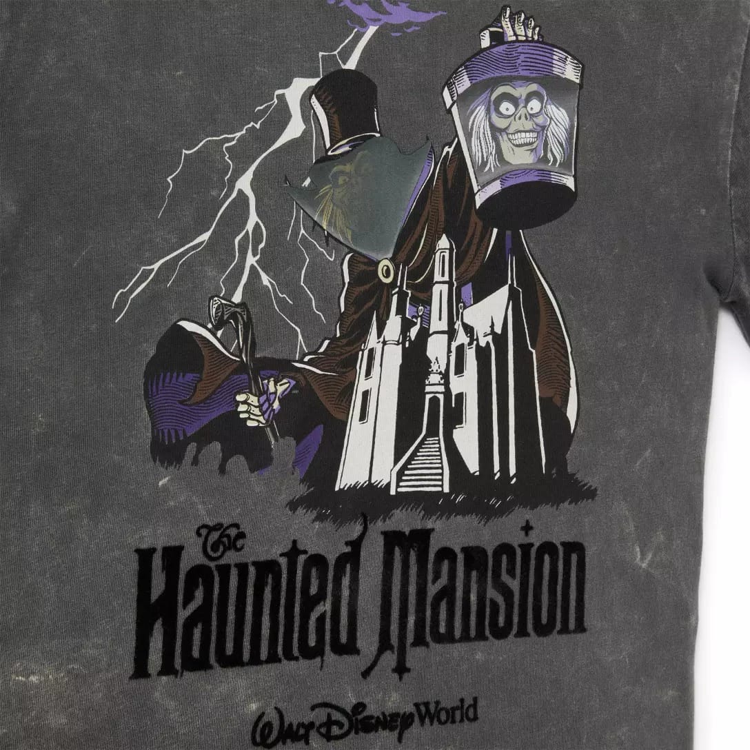 A graphic of the Hatbox Ghost and mansion from the Haunted Mansion Collection, with lightning, on a dark Disney Store shirt.