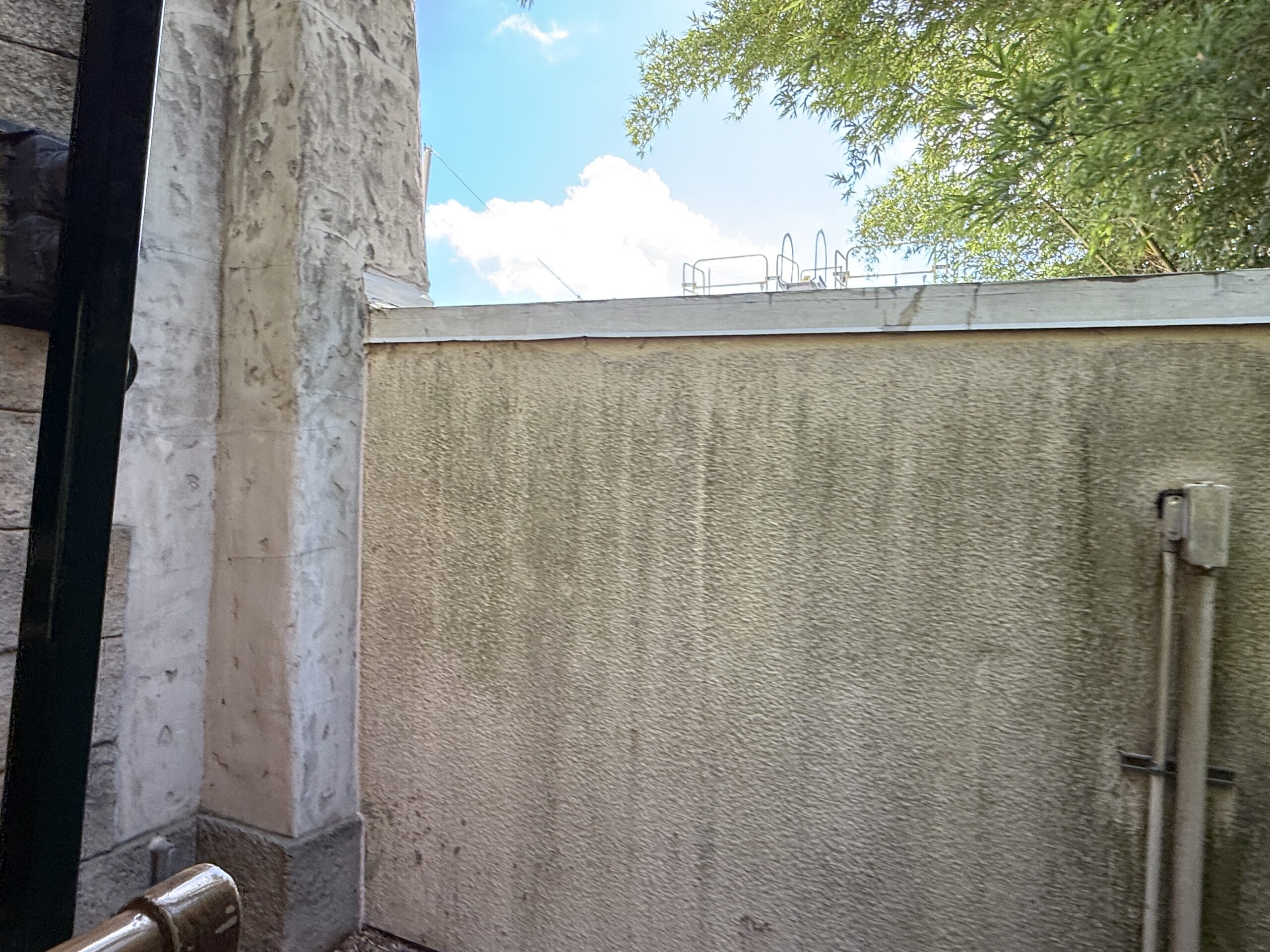 Outdoor view of a tall concrete wall at Frontierland Station Closure on the Walt Disney World Railroad complete loop.