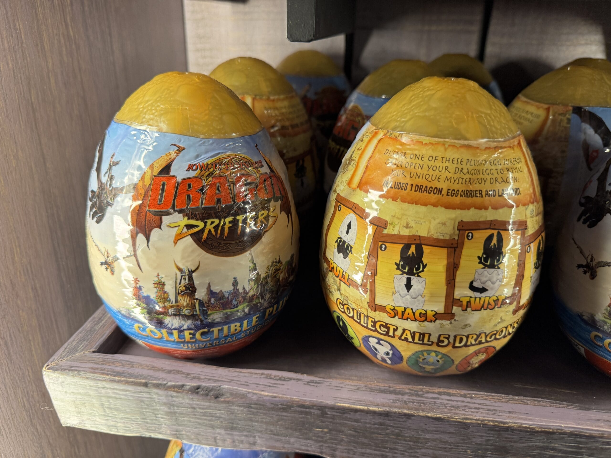Colorful Dragon Drifter eggs from Hiccup's Work Shop on a shelf, with dragon-themed packaging and instructions.