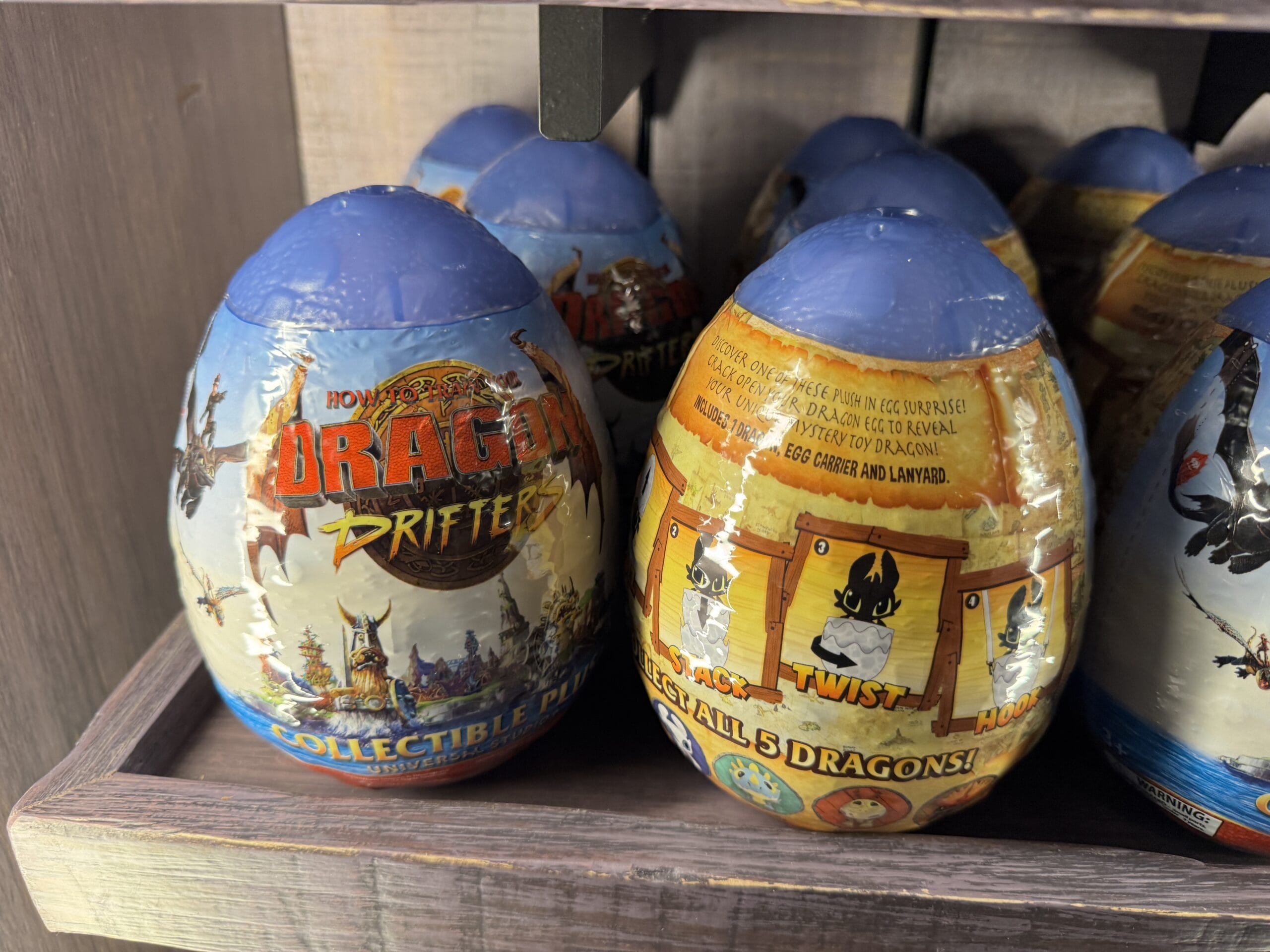 How to Train Your Dragon Drifter collectible eggs from Hiccup's Work Shop, wrapped in colorful packaging on the shelf.