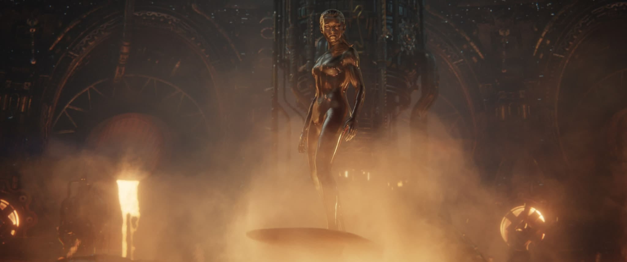 A humanoid figure covered in metallic material stands amid smoke, like a First Steps scene from Fantastic Four.