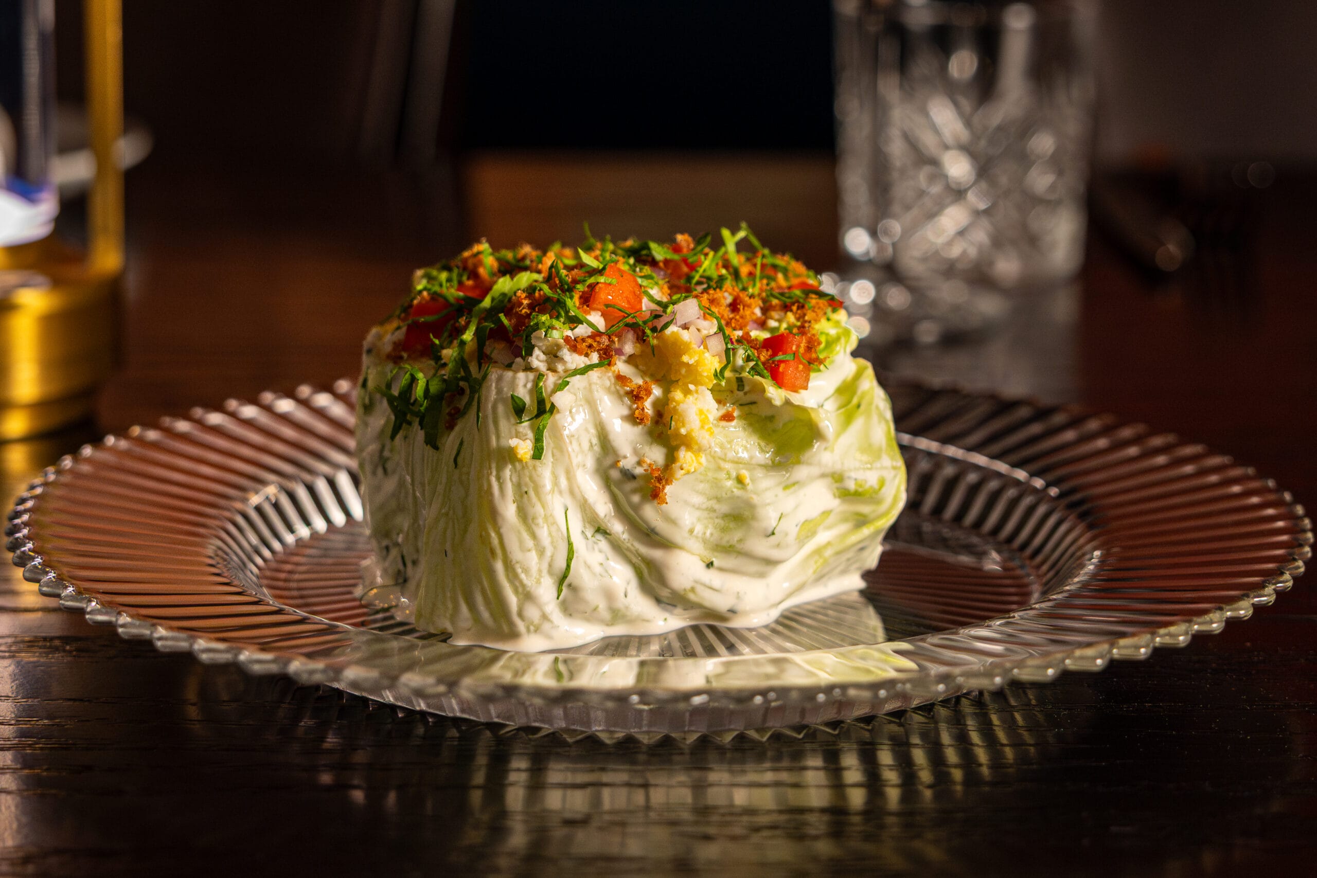 A wedge salad at Bourbon Steak, Michael Mina’s restaurant in the Walt Disney World Dolphin Hotel, on a dark table.