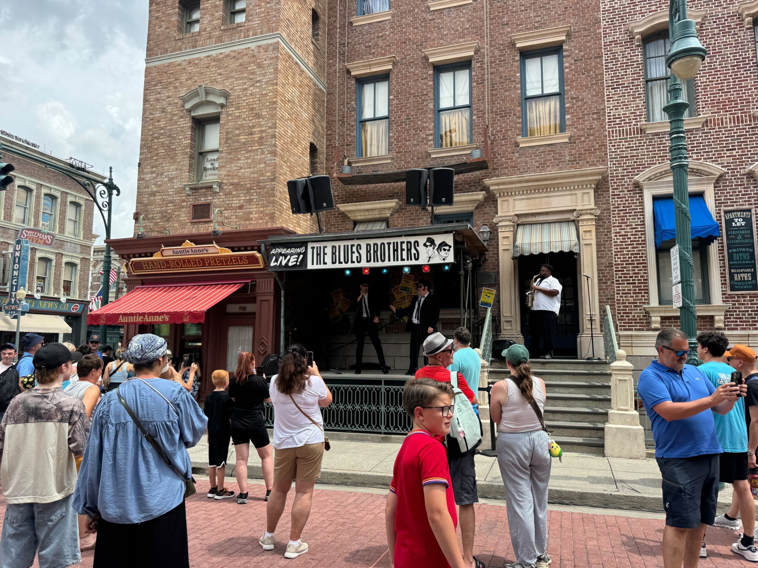 A crowd watches The Blues Brothers perform on an outdoor stage in Universal Studios Florida.